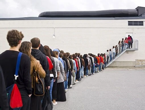 Long line of job applicants waiting for interviews, illustrating high interest in open positions and a competitive hiring process.