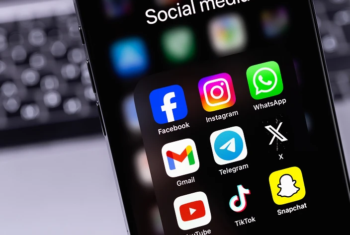 Phone screen displaying popular social media icons such as Facebook, Instagram, Twitter, and LinkedIn, representing digital communication, online presence, and social networking platforms